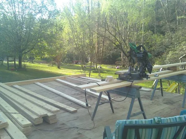 Miter saw and framing lumber on a deck under construction in La Verne