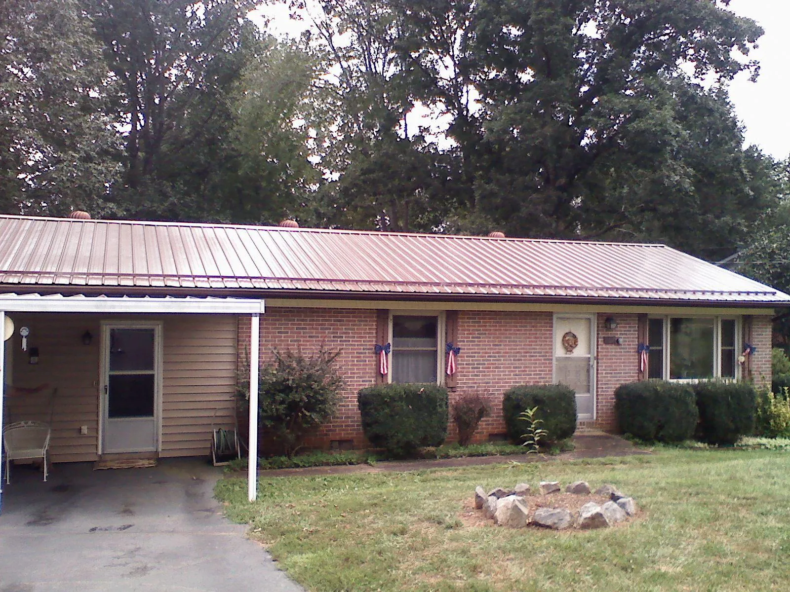 Bronze metal roof and carport on a brick ranch home — Roof Repair work by our crew in La Verne